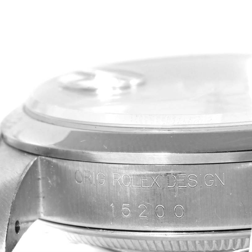 The image shows a macro shot of the case side and bezel of a Rolex Date 15200 Men's Stainless Steel White Dial 15200 Men's Stainless Steel White Dial model, highlighting the inscription "ORIG ROLEX DESIGN 15200."