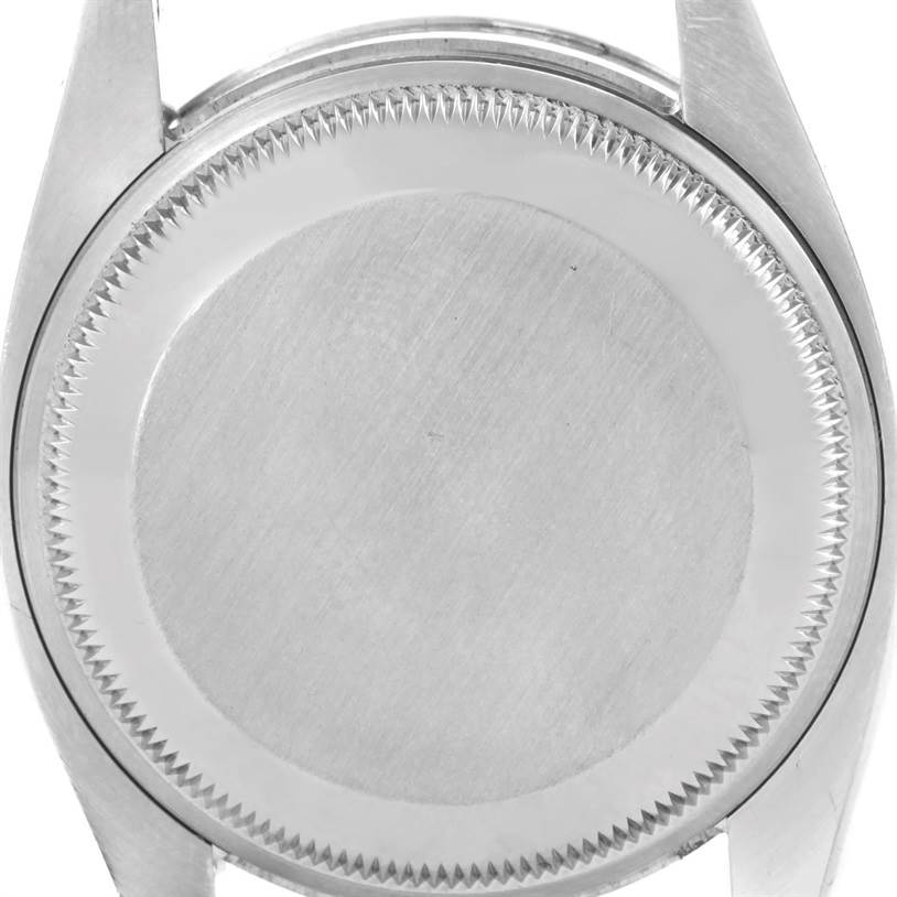 The image shows the back case of a Rolex Date 115200 Men's Stainless Steel Black Dial 115200 Men's Stainless Steel Black Dial model watch from a close-up, rear view angle.