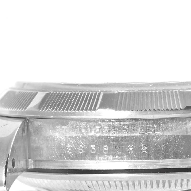 The image shows a close-up side view of the bezel and case of a Rolex Date 115200 Men's Stainless Steel Black Dial 115200 Men's Stainless Steel Black Dial watch.