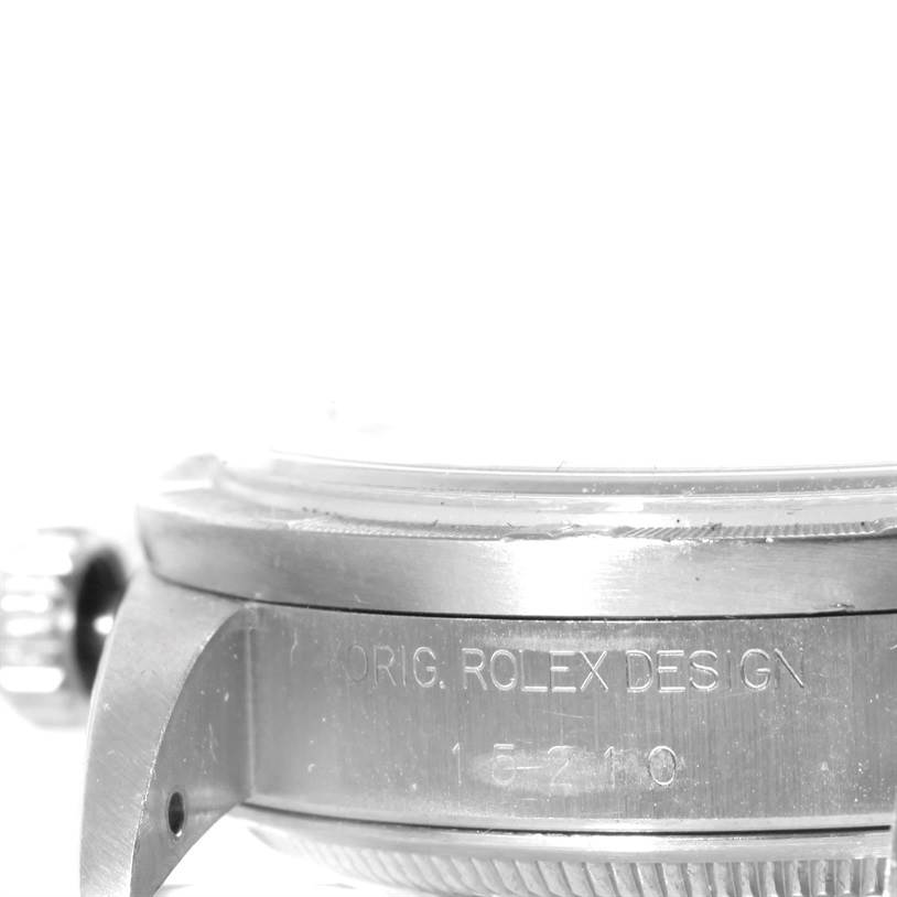 The image shows a close-up side view of the case and bezel of a Rolex Date 15210 Men's Stainless Steel Black Dial 15210 Men's Stainless Steel Black Dial model watch, including the crown and engraving.