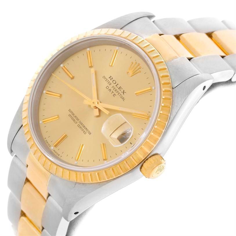 This image shows a Rolex Date 15223 Men's Steel and Gold (two tone) Champagne Dial 15223 Men's Steel and Gold (two tone) Champagne Dial model watch from a side angle, highlighting its dial, crown, fluted bezel, and two-tone bracelet.