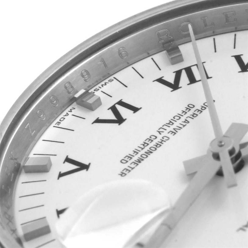 The image shows a close-up of the dial, bezel, and the seconds hand of a Rolex Date 115200SRO Men's Stainless Steel White Dial 115200SRO Men's Stainless Steel White Dial model watch at an angle.