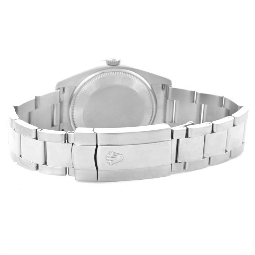 The image shows the back view of a Rolex Date 115200SRO Men's Stainless Steel White Dial 115200SRO Men's Stainless Steel White Dial model watch, featuring its clasp and bracelet.