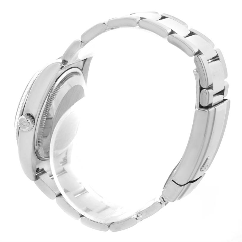 The image shows a side view of a Rolex Date 115234WRO Men's Stainless Steel White Dial 115234WRO Men's Stainless Steel White Dial model watch, highlighting the case, crown, and bracelet.