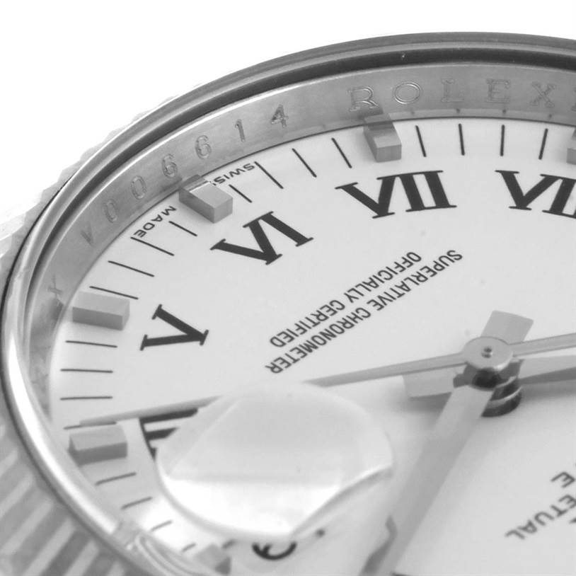 This close-up view shows the dial, Roman numerals, Cyclops lens, and part of the bezel of a Rolex Date 115234WRO Men's Stainless Steel White Dial 115234WRO Men's Stainless Steel White Dial model.