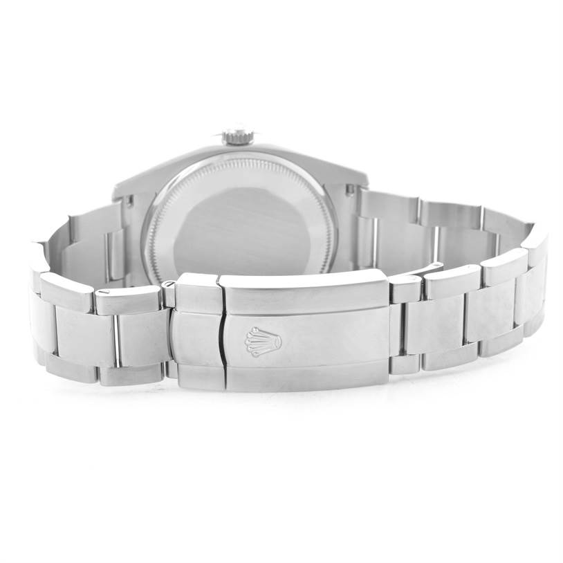 This image shows the back case and the clasp of the bracelet of a Rolex Date 115234WRO Men's Stainless Steel White Dial 115234WRO Men's Stainless Steel White Dial model watch.