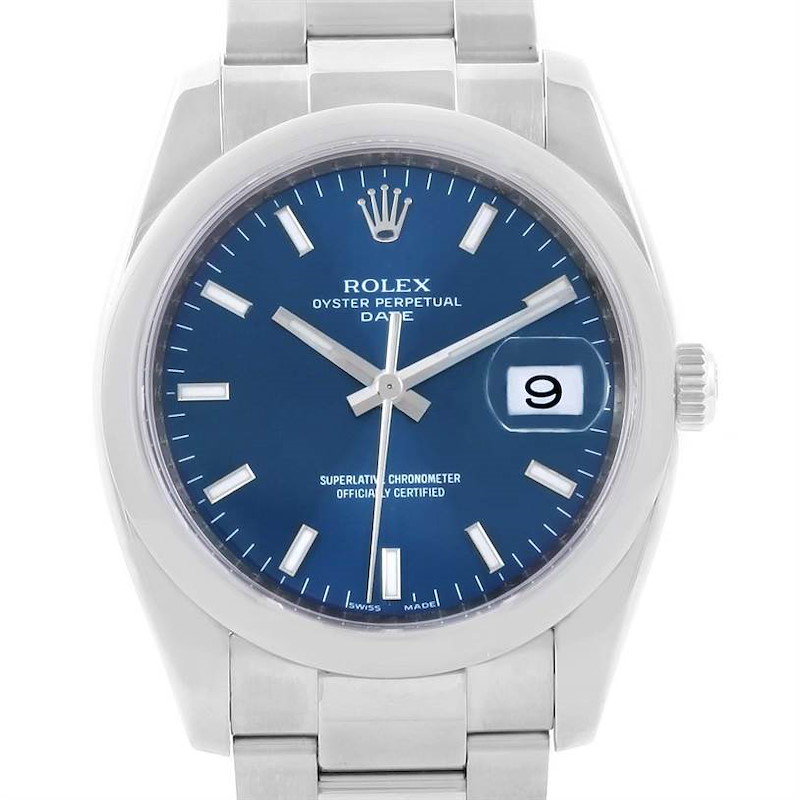 The image shows a front view of a Rolex Date model watch, highlighting its blue dial, date window, and stainless steel bracelet.