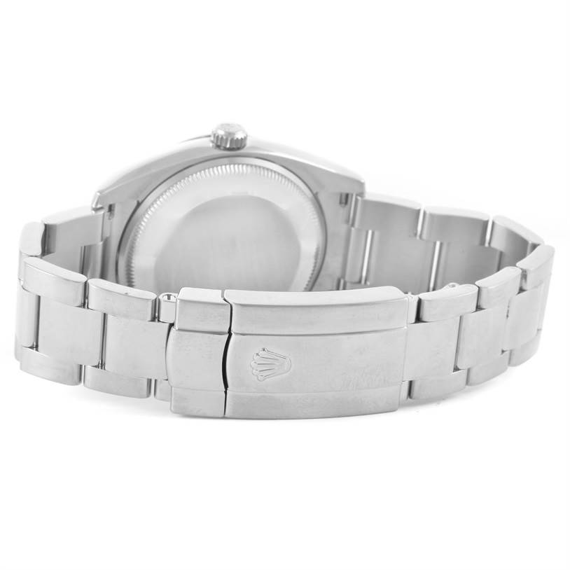 The image shows the backside and clasp of a Rolex Date 115200 Men's Stainless Steel Blue Dial 115200 Men's Stainless Steel Blue Dial model watch, highlighting its bracelet and casing.