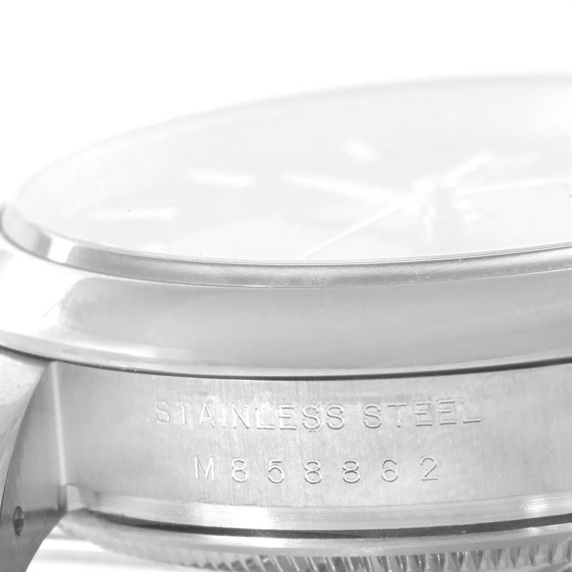 This is a close-up side view of the stainless steel case and bezel of the Rolex Date 115200 Men's Stainless Steel Blue Dial 115200 Men's Stainless Steel Blue Dial model watch.