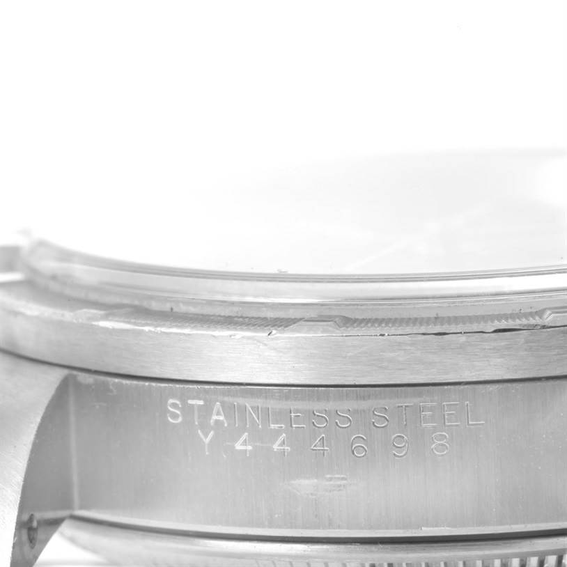This image shows a close-up of the side and bezel of a stainless steel Rolex Date 15210 Men's Stainless Steel Black Dial 15210 Men's Stainless Steel Black Dial model watch, displaying its serial number.