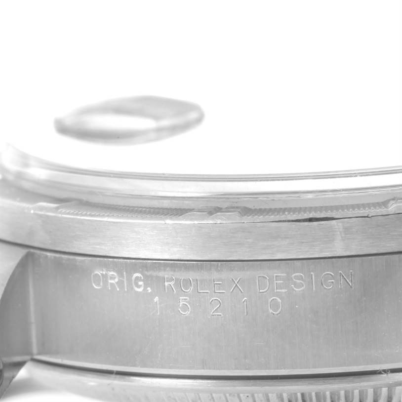 This image shows a close-up side view of the case and crystal of the Rolex Date 15210 Men's Stainless Steel Black Dial 15210 Men's Stainless Steel Black Dial, including etched text and the model number 15210.