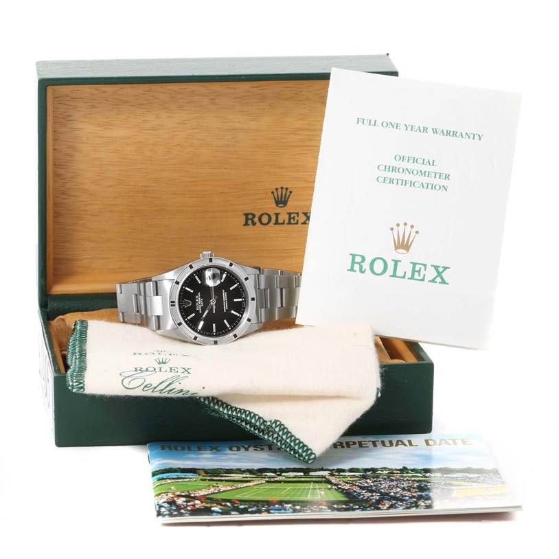 The image shows a Rolex Date 15210 Men's Stainless Steel Black Dial 15210 Men's Stainless Steel Black Dial model watch, lying in an open box with warranty papers and a booklet.