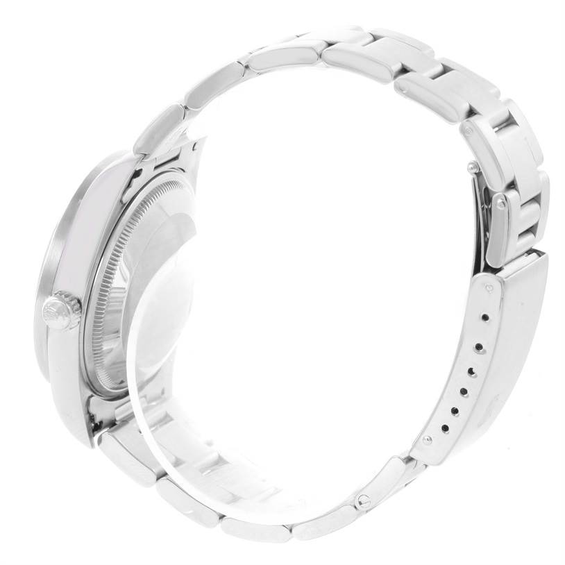 The image shows a side view of a Rolex Date 15210 Men's Stainless Steel Blue Dial 15210 Men's Stainless Steel Blue Dial model watch, highlighting its case, crown, and part of the metal bracelet.