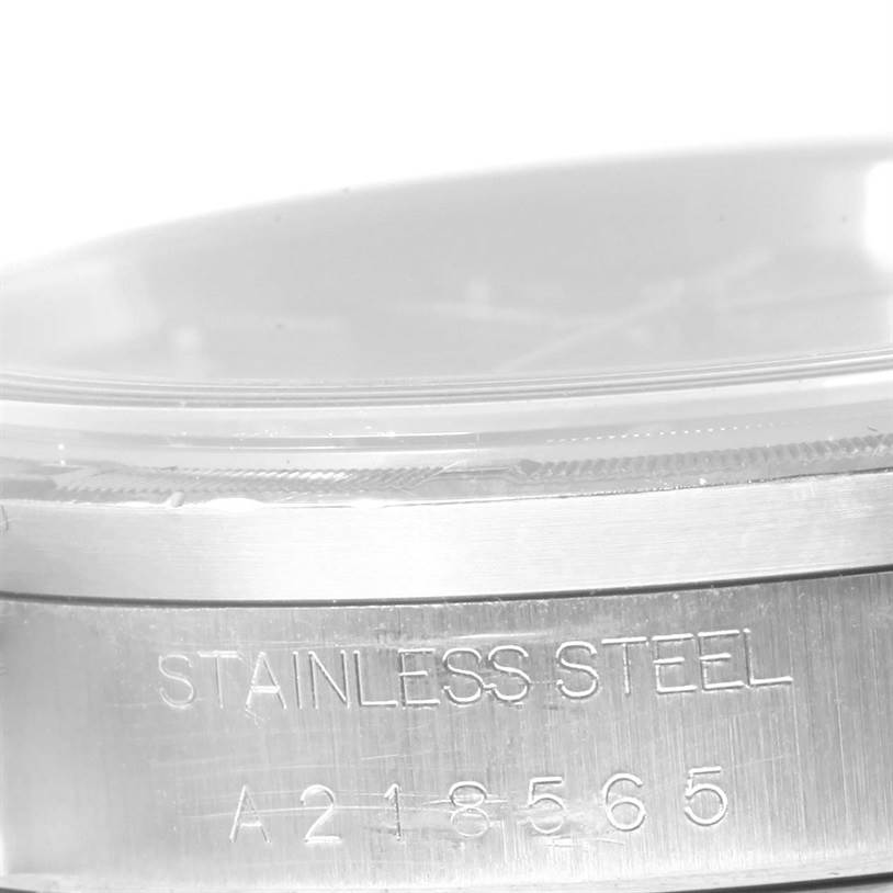 The image shows a close-up of the case side, bezel, and serial number engraving of a Rolex Date 15210 Men's Stainless Steel Blue Dial 15210 Men's Stainless Steel Blue Dial model watch.