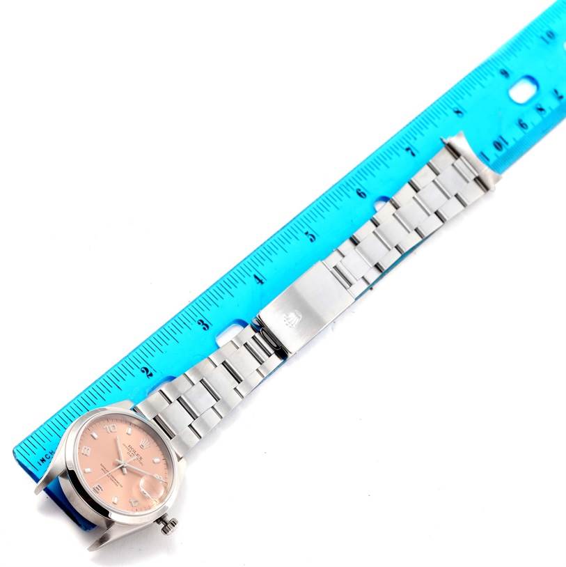 The Rolex Date 15200 Men's Stainless Steel Pink Dial 15200 Men's Stainless Steel Pink Dial model watch is shown from a top view angle, displaying the wristband, clasp, and part of the face.