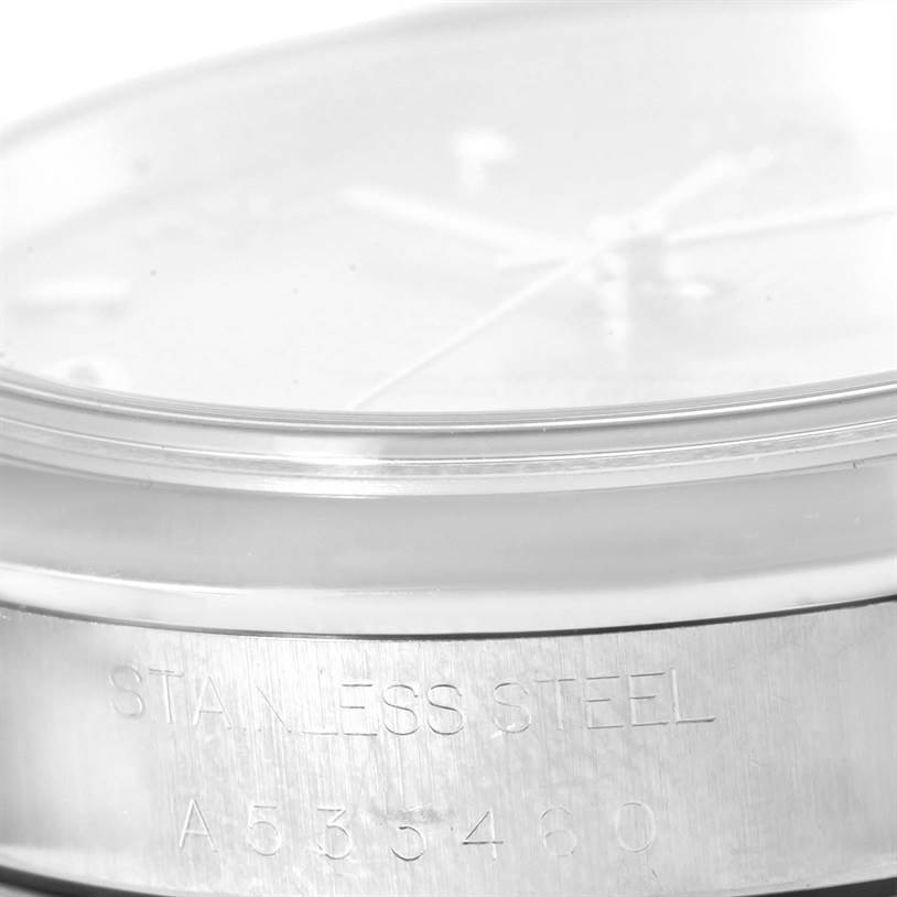 The image shows a side view of a Rolex Date 15200 Men's Stainless Steel Pink Dial 15200 Men's Stainless Steel Pink Dial model watch focusing on the case with engraved text "STAINLESS STEEL" and a serial number.