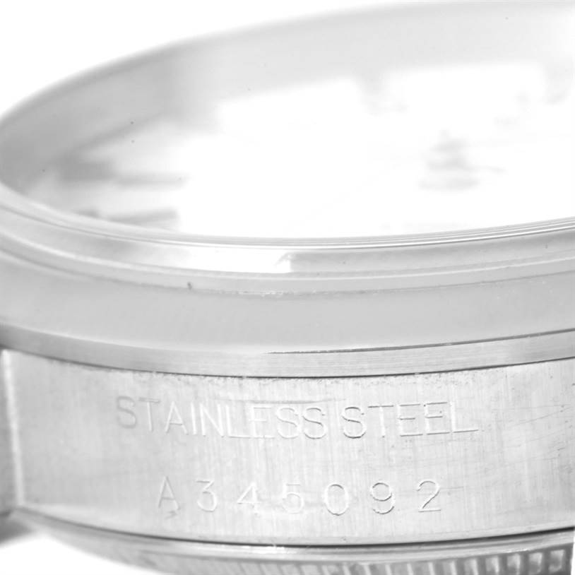 This image shows a close-up of the stainless steel case back and serial number on a Date model by Rolex.