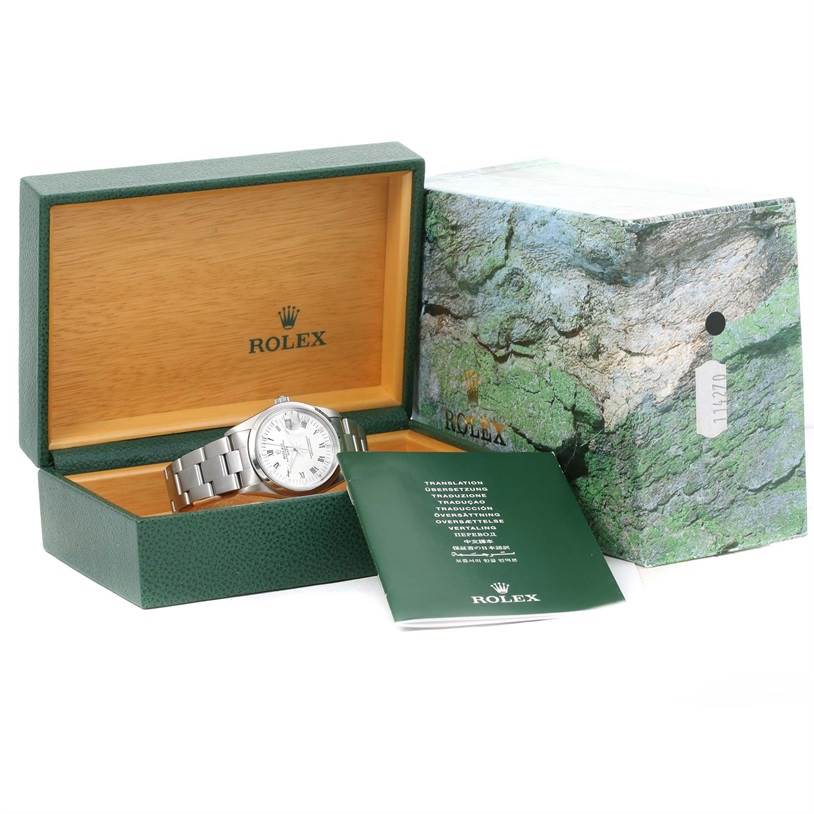 The Rolex Date 15200 Men's Stainless Steel  15200 Men's Stainless Steel  model watch is shown in its open green box, with an instruction manual and outer box visible.