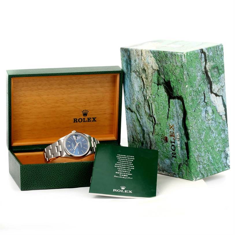 This image shows a Rolex Date 15200 Men's Stainless Steel Blue Dial 15200 Men's Stainless Steel Blue Dial model watch at a slight angle, displayed in an open green box with its outer box and booklet.