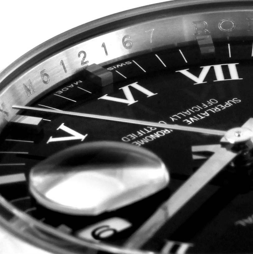 A close-up angle of the Rolex Date 115200 Men's Stainless Steel Black Dial 115200 Men's Stainless Steel Black Dial model shows the numbers, hands, and magnified date window on the watch face.