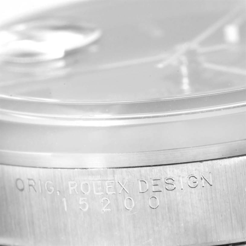 This image shows a close-up of the bezel and case of a Rolex Date 15200 Men's Stainless Steel Black Dial 15200 Men's Stainless Steel Black Dial model, revealing the inscription "ORIG. ROLEX DESIGN 15200."