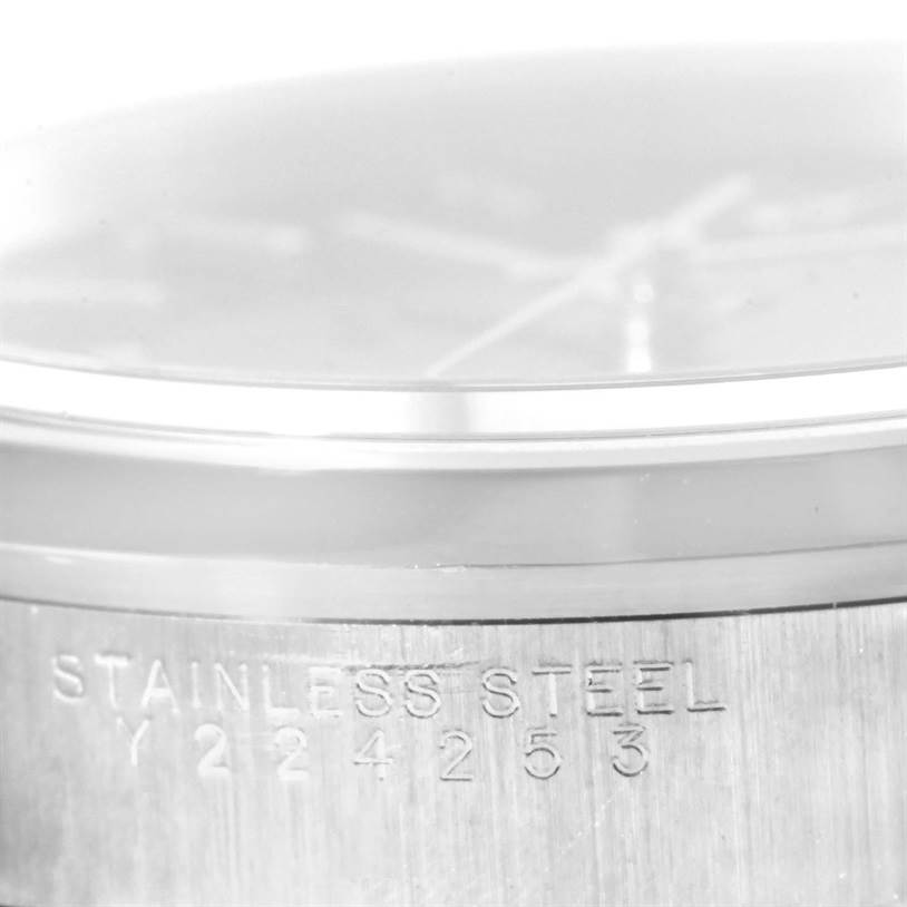 This image shows the side of the Rolex Date 15200 Men's Stainless Steel Black Dial 15200 Men's Stainless Steel Black Dial model watch, focusing on the stainless steel case with engraved serial numbers.