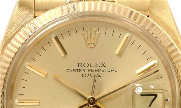 The image shows a close-up of the face of a Rolex Date 1503 Men's Yellow Gold Champagne Dial 1503 Men's Yellow Gold Champagne Dial model, highlighting its dial, hands, date window, and fluted bezel.