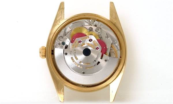 This image shows the internal mechanism of a Rolex Date 1503 Men's Yellow Gold Champagne Dial 1503 Men's Yellow Gold Champagne Dial model watch from a back angle without its case back.