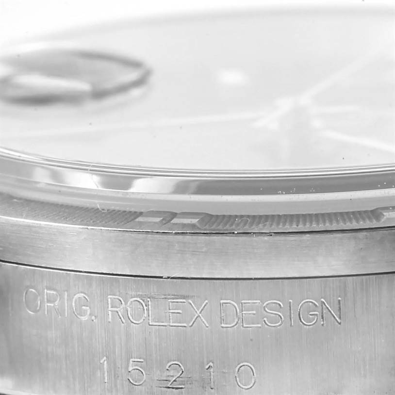 The image shows a close-up side view of the bezel and casing of the Rolex Date 15210 Men's Stainless Steel Blue Dial 15210 Men's Stainless Steel Blue Dial model watch, featuring the model number 15210 and "Orig. Rolex Design" engraving.