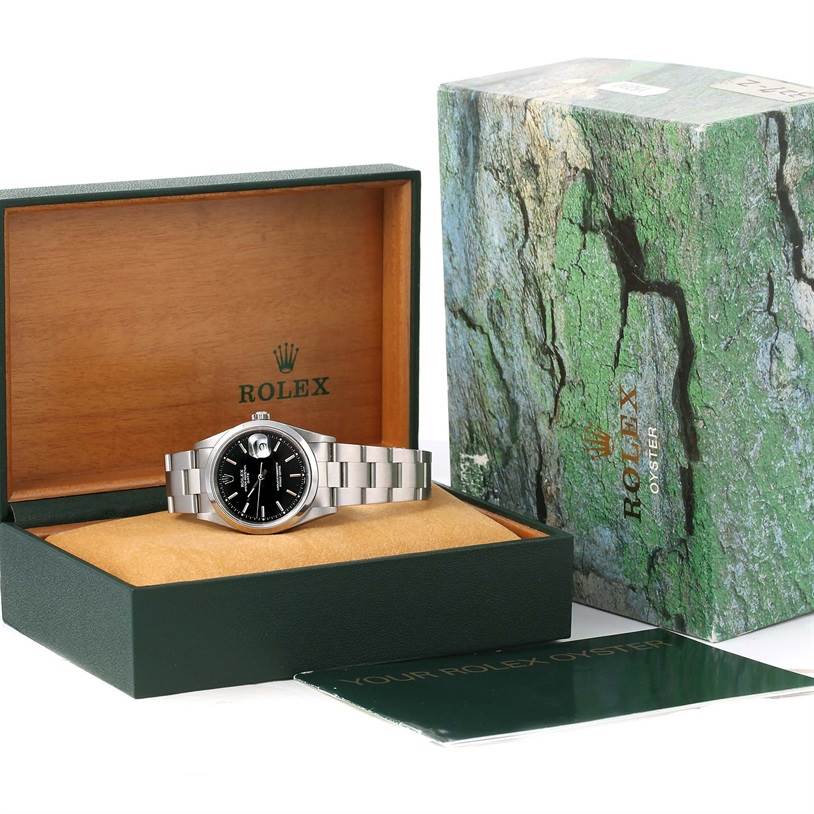 The Rolex Date 15200 Men's Black Dial 15200 Men's Black Dial model watch is shown inside its open box with the outer packaging and booklet visible.