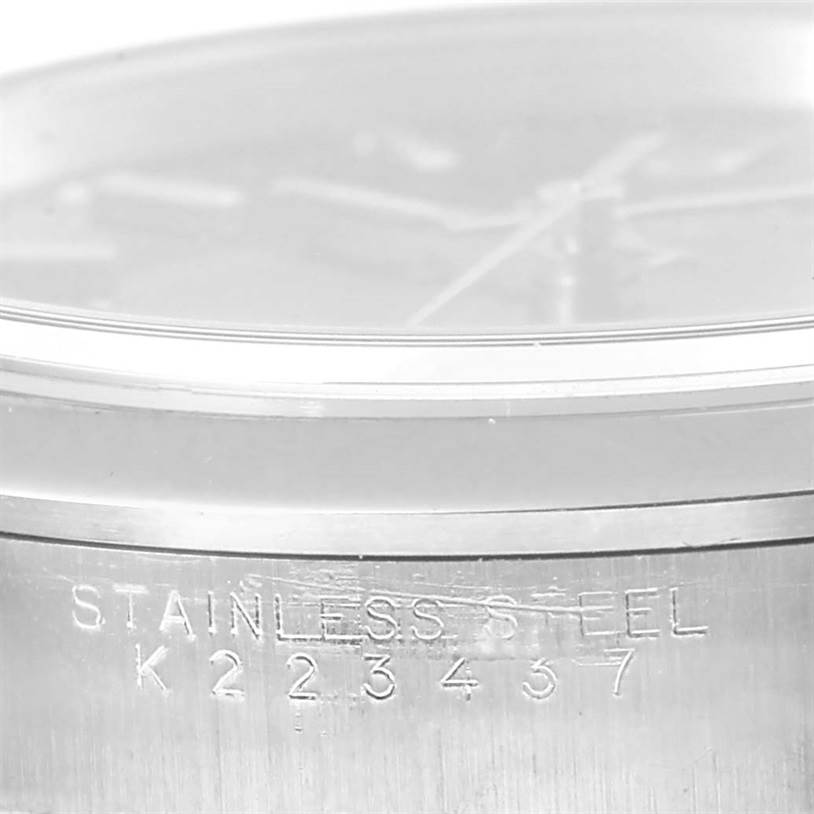 This image shows a close-up of the side of a Rolex Date 15200 Men's Black Dial 15200 Men's Black Dial model watch, highlighting the stainless steel material and serial number.