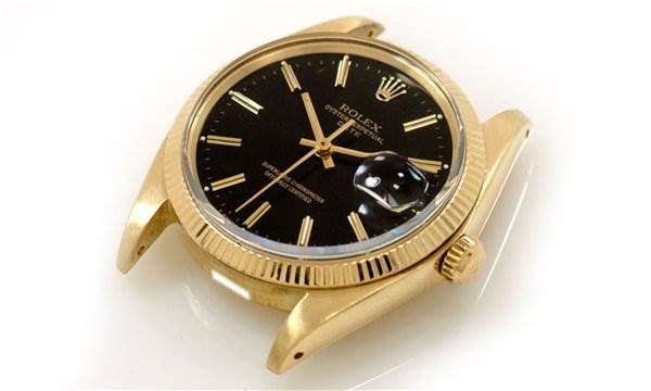 The image shows a Rolex Date 1503 Men's Yellow Gold Black Dial 1503 Men's Yellow Gold Black Dial watch sans strap, highlighting the dial, bezel, case, and crown from an angled side view.