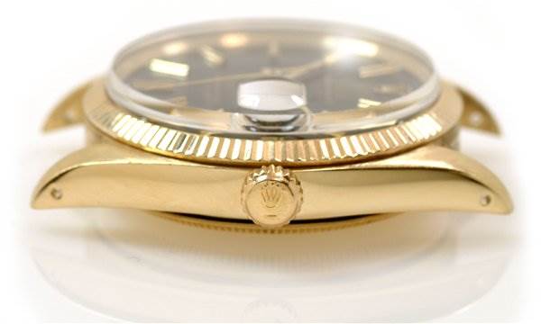 The image shows a close-up side view of a Rolex Date 1503 Men's Yellow Gold Black Dial 1503 Men's Yellow Gold Black Dial model watch, highlighting the crown, bezel, and case.