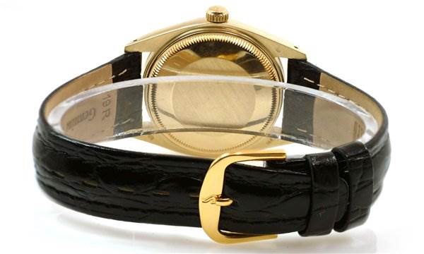 The image shows the back view of a Rolex Date 1503 Men's Yellow Gold Black Dial 1503 Men's Yellow Gold Black Dial model watch, highlighting its clasp, black leather strap, and gold case.