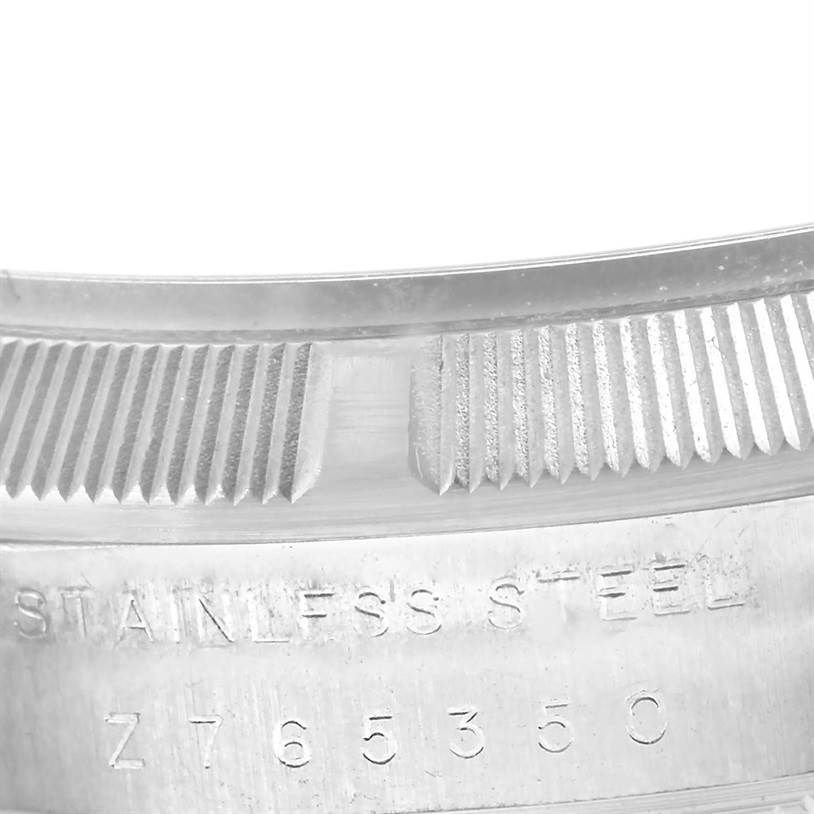This image shows a close-up of the bezel and engraved case of the Rolex Date 115210 Men's Stainless Steel White Dial 115210 Men's Stainless Steel White Dial model watch.