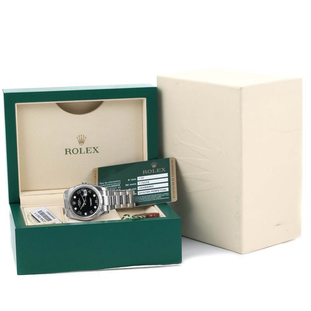 The image shows a Rolex Date 115234 Men's Stainless Steel Black Dial 115234 Men's Stainless Steel Black Dial model watch, its box, warranty card, and white outer cover from a front angle.