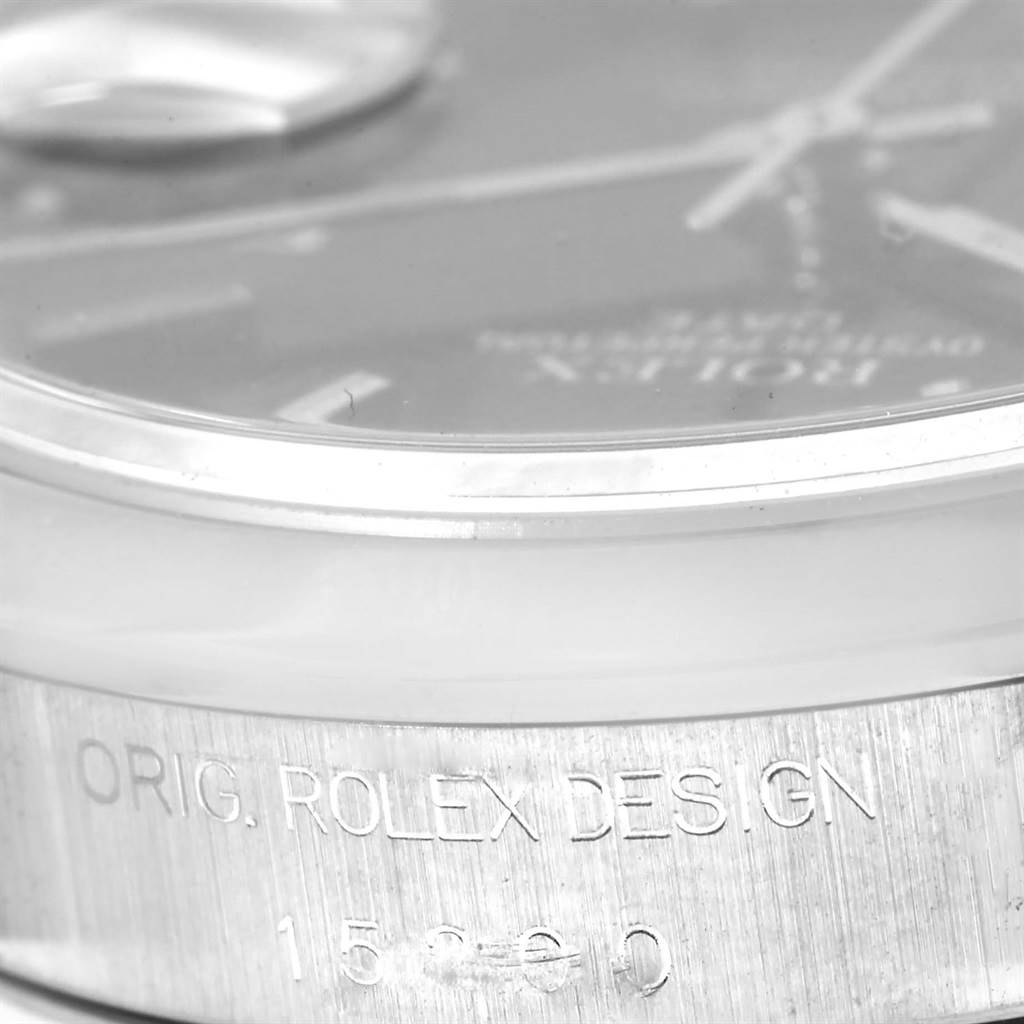 The image shows a close-up of the side and part of the dial of a Rolex Date 15200 Men's Stainless Steel Black Dial 15200 Men's Stainless Steel Black Dial model.