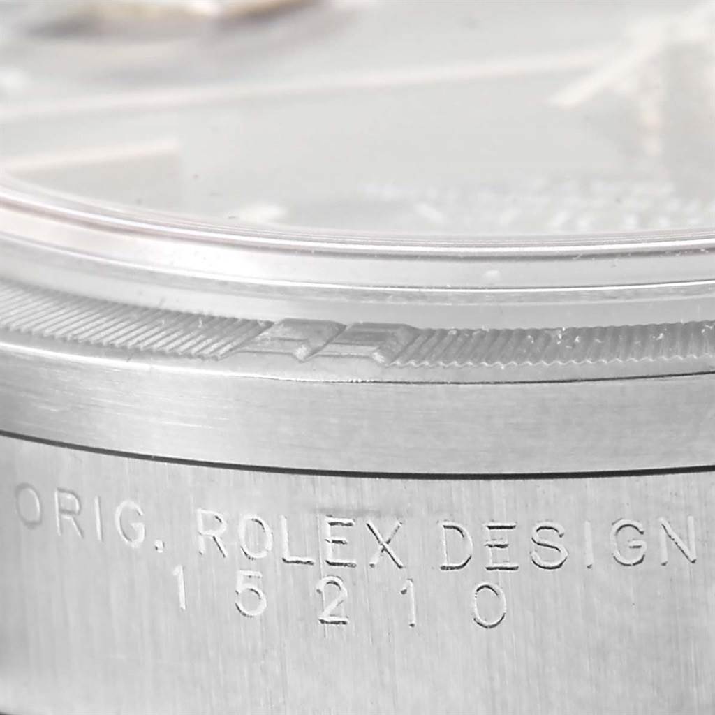 The image shows a close-up of the case with the engraved design number of a Rolex Date 15210 Men's Stainless Steel Blue Dial 15210 Men's Stainless Steel Blue Dial watch.