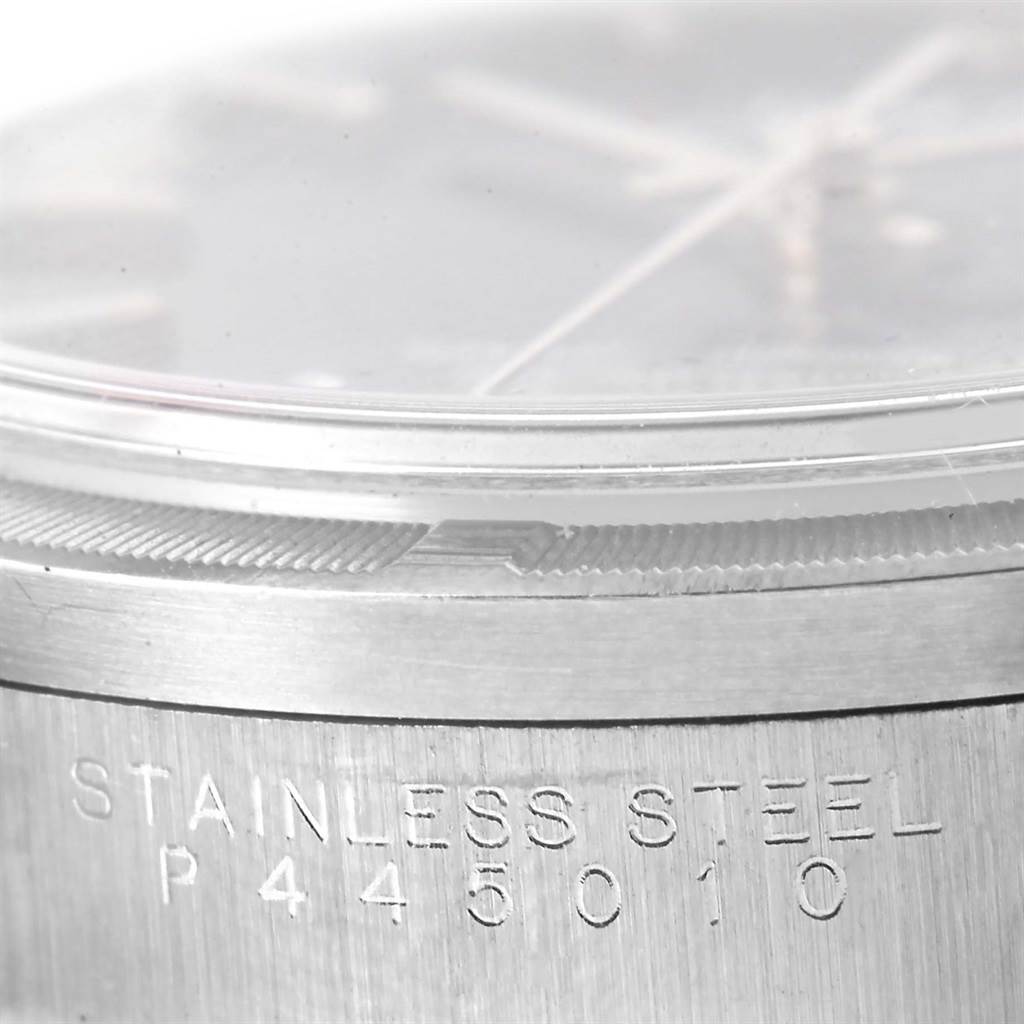 This image shows a close-up angled view of the case side and bezel of a Rolex Date 15210 Men's Stainless Steel Blue Dial 15210 Men's Stainless Steel Blue Dial model watch, highlighting the stainless steel marking.