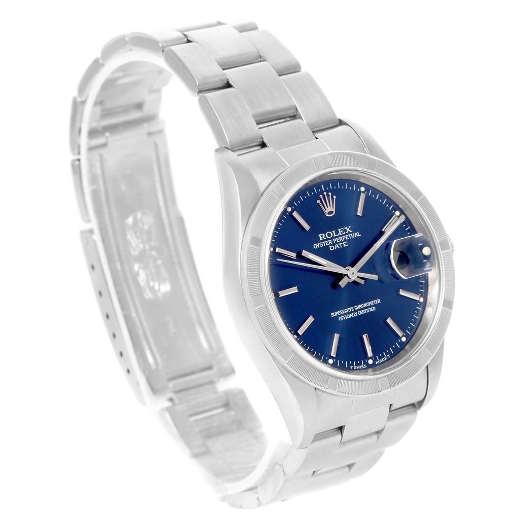 The image shows a Rolex Oyster Perpetual Date watch, angled to display its blue dial, stainless steel case, and bracelet.