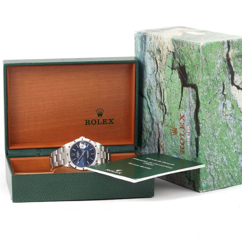 The Rolex Date 15210 Men's Stainless Steel Blue Dial 15210 Men's Stainless Steel Blue Dial watch is shown in its open box with accompanying paperwork and outer packaging.