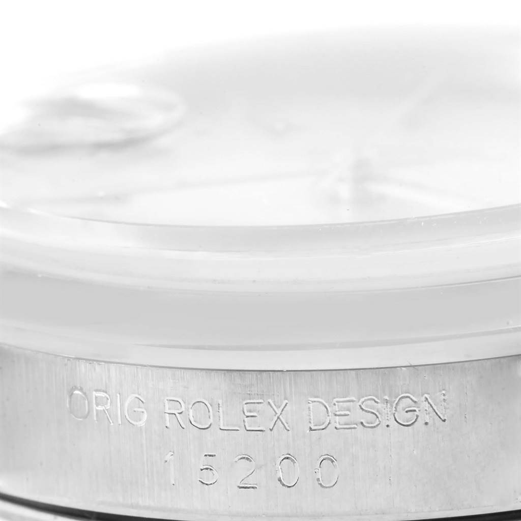 The image shows a close-up of the side of a Rolex Date 15200 Men's Stainless Steel Silver Dial 15200 Men's Stainless Steel Silver Dial model watch, focusing on the case with the engraving "ORIG ROLEX DESIGN 15200."