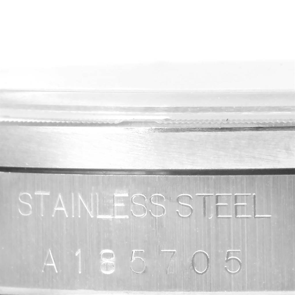 The image shows a close-up of the case side of a Rolex Date 15210 Men's Stainless Steel Black Dial 15210 Men's Stainless Steel Black Dial model watch, highlighting its "STAINLESS STEEL" engraving and model number.