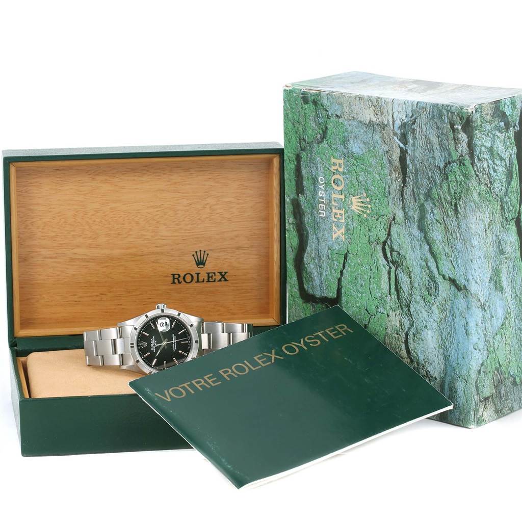 The image shows a Rolex Date 15210 Men's Stainless Steel Black Dial 15210 Men's Stainless Steel Black Dial model watch in its open box along with the outer box and a booklet.