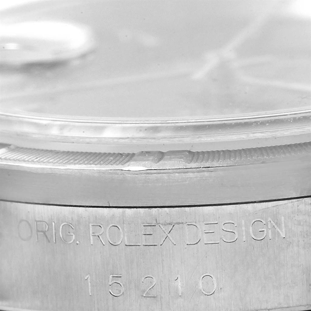 Close-up of the side view of a Rolex Date 15210 Men's Stainless Steel Black Dial 15210 Men's Stainless Steel Black Dial model, showing the serial number engraved on the case.