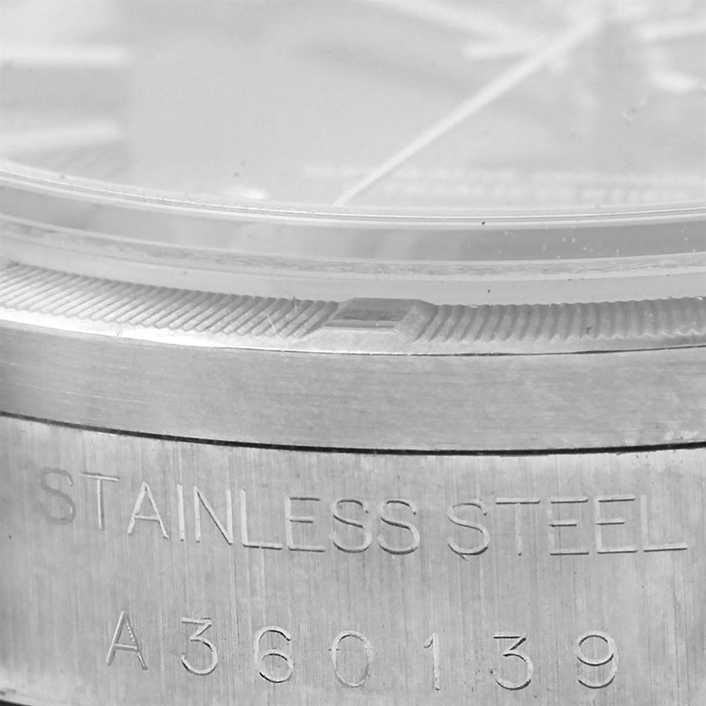 This close-up angle shows the outer edge and serial number of a Rolex Date 15210 Men's Stainless Steel Black Dial 15210 Men's Stainless Steel Black Dial stainless steel watch.