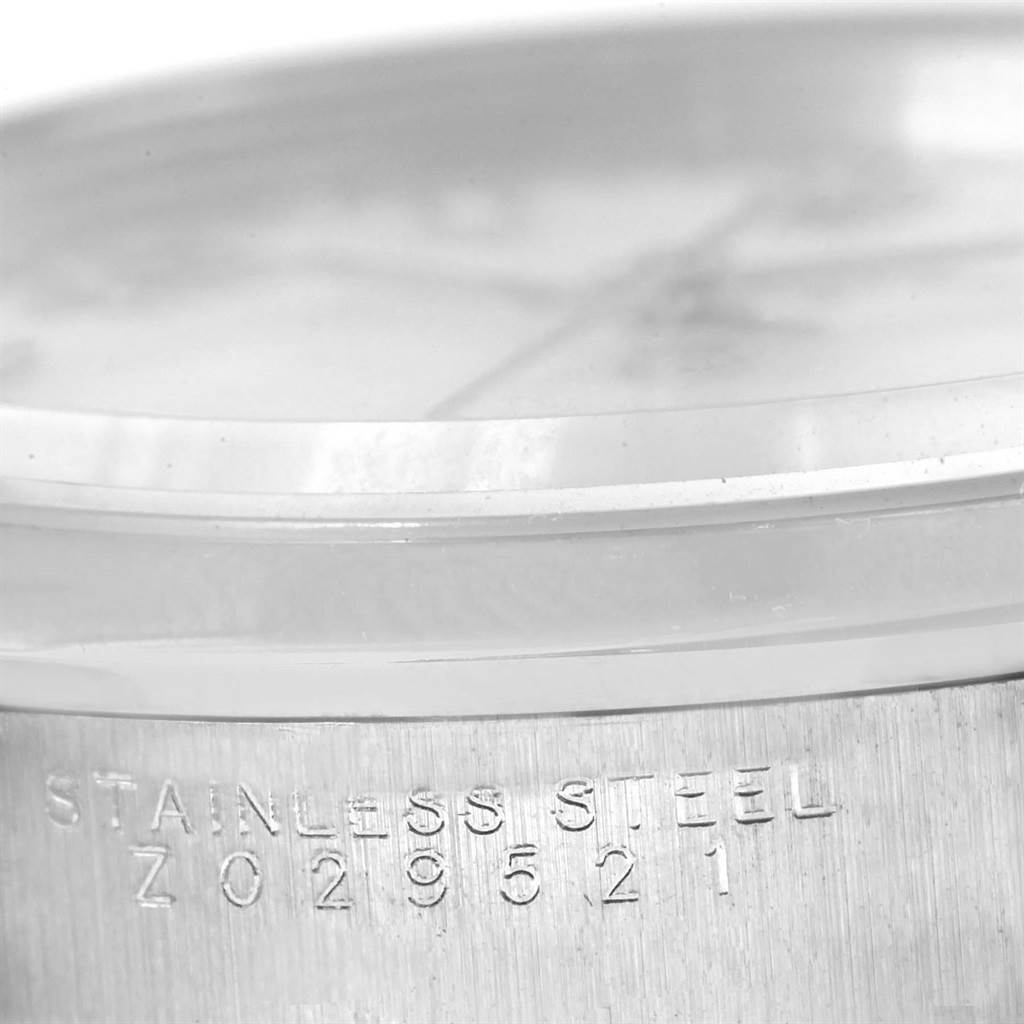The image shows a close-up angle of the casing side of a Rolex Date 15200 Men's Stainless Steel White Dial 15200 Men's Stainless Steel White Dial model watch, featuring "Stainless Steel" and a serial number.
