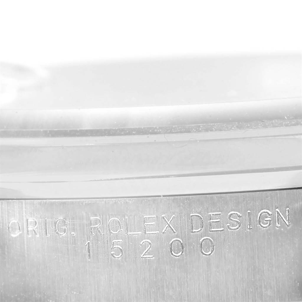 The image shows a close-up of the case side of a Rolex Date 15200 Men's Stainless Steel White Dial 15200 Men's Stainless Steel White Dial model with the engraving "ORIG. ROLEX DESIGN 15200".