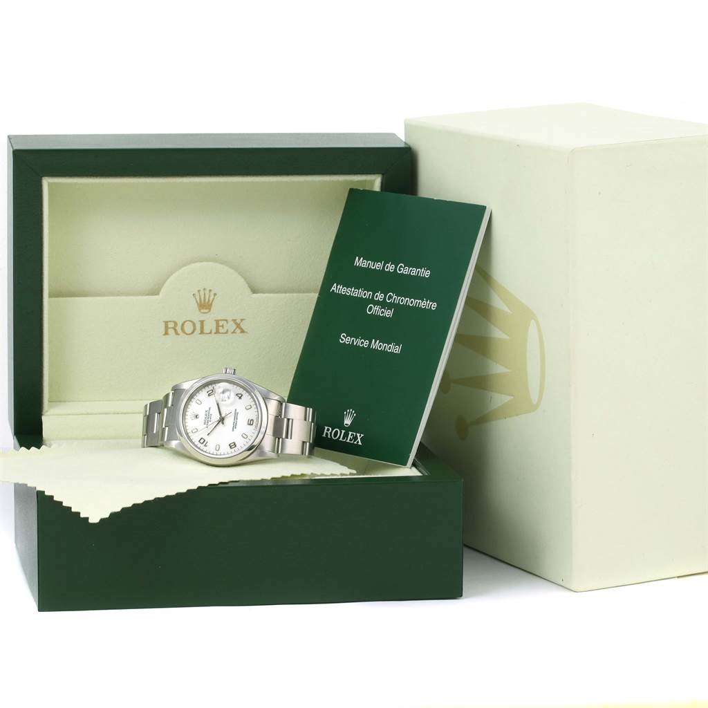 The image shows a Rolex Date 15200 Men's Stainless Steel White Dial 15200 Men's Stainless Steel White Dial model watch, partially displayed, in its open box with warranty booklets and a cleaning cloth.