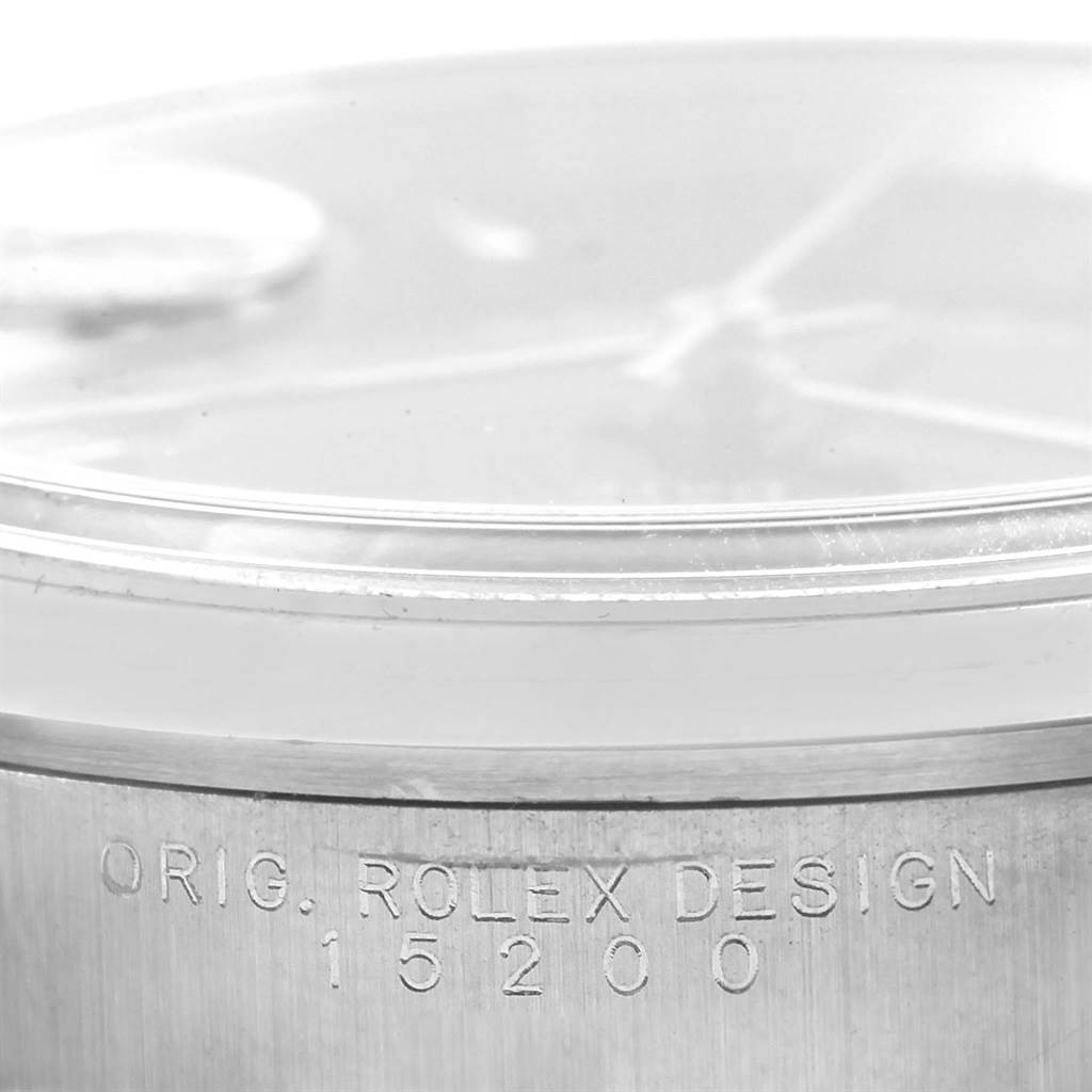 The image shows a close-up of the case side of a Rolex Date 15200 Men's Stainless Steel Black Dial 15200 Men's Stainless Steel Black Dial model, featuring the inscription "ORIG. ROLEX DESIGN 15200."